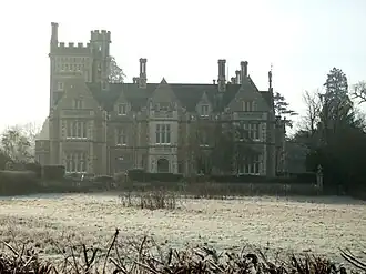 A grand country house behind a lawn