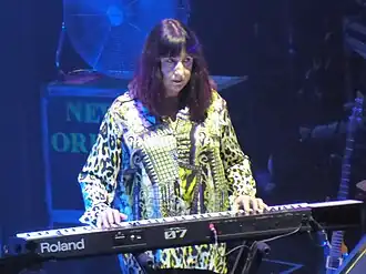 Gilbert on stage with New Order in 2019