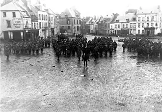 New Zealand soldiers of the 4th Battalion of the New Zealand Rifle Brigade, gathered in the market square of Le Quesnoy the day after the recapture of the town during World War I.