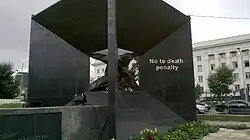 A black monument reading, "No to Death Penalty"
