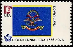 The North Dakota state flag as depicted in the 1976 bicentennial postage stamp series.