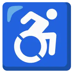 Emoji of the Accessible Icon, depicting a white line figure of a person leaning forward, arm raised to propel a wheelchair on blue background