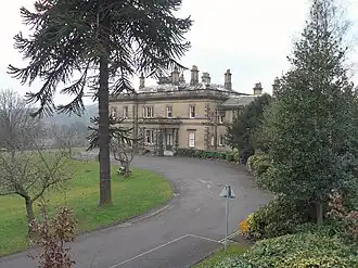 small two-storey building in a parkland setting