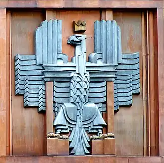 Polish coat of arms (unofficial) in Art Deco style, on the façade of the post office in Warsaw (architect Julian Puterman-Sadłowski, 1934)