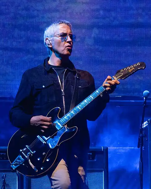 Archer performing with Oasis in July 2025