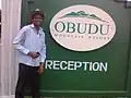 A man posing by the reception post of Obudu Mountain Resort