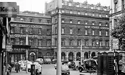 The main entrance to the old station on Stephenson Street, including Queens Hotel in 1962