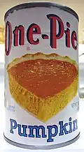 A can of pureed pumpkin, typically used as the main ingredient in the pie filling