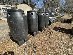 Organic Liquid fertilizer can be produced by adding green biomass to tanks of water, adding leaf mold, and then allowing anaerobic fermentation and decay to occur. The microbes break down nutrients in the biomass which can then be used to fertilize garden plants.