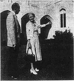 A founding member of the church points out a feature of the original section of the church building (The Roberts News, 1959)