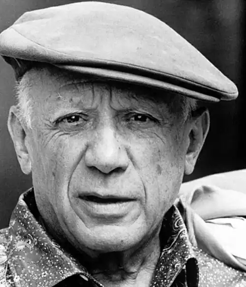 Black-and-white photo of Picasso in a coat
