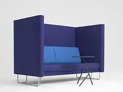 A sofa with high arms/seat back for meetings and or extra privacy in public spaces, designed by Busk-Hertzog in 2011.