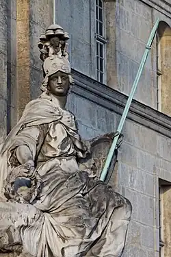 The portal is guarded by a statue of the Goddess Minerva