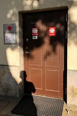 Side door of the Church of St. Anthony of Padua (Kaunas)&nbsp;[lt] with signs of the local parish Caritas.