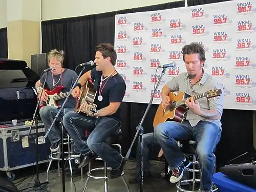 Country music band Parmalee, performing on a stage.
