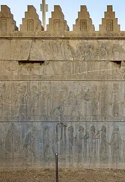 Persian Achaemenid rosette friezes on a wall, c.490 BC, limestone, in situ, Persepolis, Iran[9]