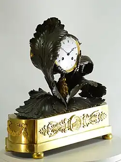 Neoclassical French mantel clock « Aux feuilles de chou » (with cabbage leaves), ormolu and patinated bronze. The clock case by Pierre-Victor Ledure, the clockwork by Claude Hémon (1770–1820)