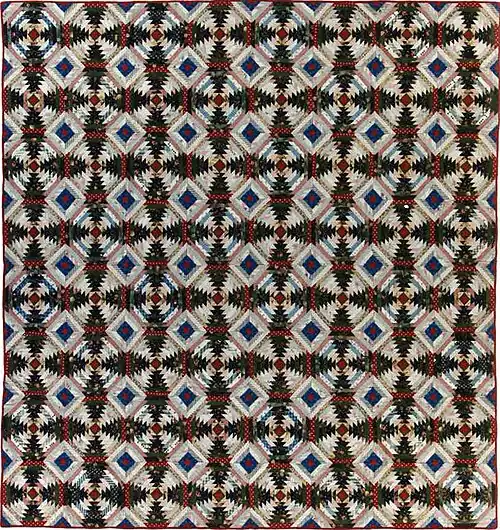 Quilt using the pineapple variation of the traditional log cabin square.