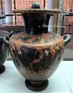 A vase with a brown background and light-skinned figures in black dress