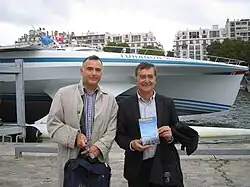 Louis Boisgibault (left), author of academic books on energy transition, meets crew.