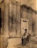 Vincenzo Galdi before a mock door on a Roman grave at Pompeii