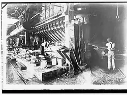BHP, Port Pirie, water jacket furnace, c.1915. Metal ingots are being cast on left and slag run off on right. The slag wagon has two pivoting cantilevered slag ladles.