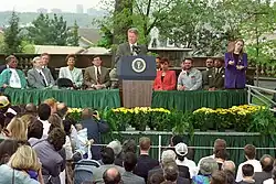 Bill Clinton delivering a speech in a front of a crowd