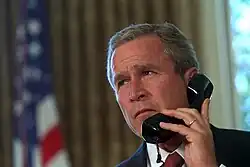 President Bush speaks on the phone to New York's Governor and Mayor respectively, George Pataki and Rudy Giuliani, two days after the September 11 attacks. (Draper, 2001)