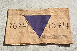 Forced labor squad armband with cloth emblem indicating a Jehovah's Witnesses detainee