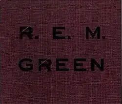 A crimson cover with rough-hewn texture that has "GREEN" and "R.E.M." debossed on it in black