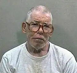 Head shot of elderly man with glasses in a white T-shirt