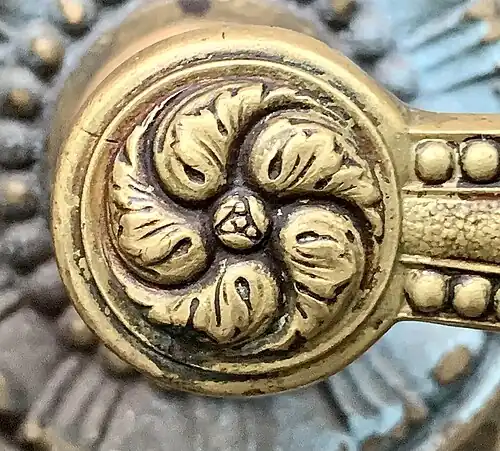 Neoclassical rosette on a handle of the lateral wing that faces Strada Edgar Quinet and Strada Academiei of the University Building, Bucharest, Romania, probably designed by Nicolae Ghica-Budești, 1914-1934[15]