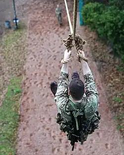 A recruit, at the start of the 'Tarzan Assault Course slides down the death slide (known as the Commando Slide).