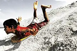 Image 56A boy sandboarding in Fuvahmulah, Maldives (from Culture of the Maldives)