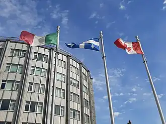 The flags of Italy, Quebec, and Canada at the entrance of the hospital