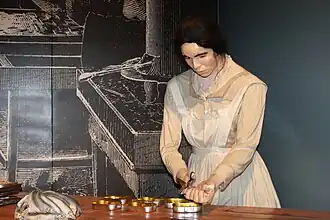 Exhibit of a woman canning sardines at the Maine State Museum in Augusta