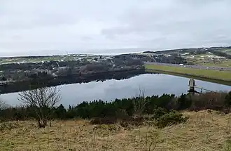 Image of a lake in wintertime with a motorway across the dam head