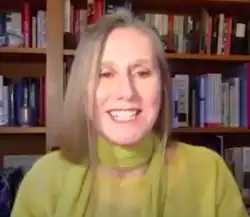 Screen shot photo of Neasa Hardiman in an online video interview, with a background of bookshelves.