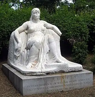 Photograph of a white marble statue depicting a seated woman