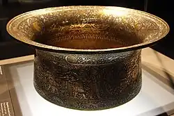 The Baptistère de Saint Louis; by Muhammad ibn al-Zayn; 1320–1340; hammering, engraving, inlay in brass, gold, and silver; 50.2 x 22.2 cm