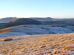 The rounded west ridge of Little Mell Fell, with Great Mell Fell beyond, and Blencathra and the Northern Fells in the distance
