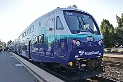 A double-decker passenger car in the Sounder livery with a large windshield in the operator's cab