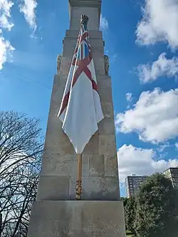 Flag carved from stone and painted as the White Ensign (a red cross on a white background with the Union Flag in the top left quadrant)
