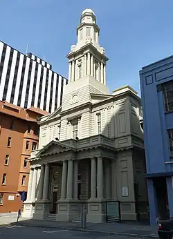 photo of concrete church with spire.