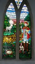 Stained glass window in St. Ethelbert's Church, Herringswell, Suffolk, England. Depicts St Hubert and the deer.