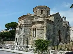 Outdoor photograph of a stone Byzantine church, with an octagonal tower