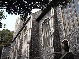 The decorative possibilities suggested by the contrast of limestone quoins against knapped flint no doubt inspired flushwork. (Church of St Peter Parmentergate, Norwich)