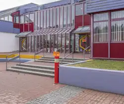 Skewed view of an elementary school with orange sign "Stimmbezirk 18"