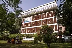 Student sitting on campus field