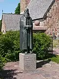 A sculpture of von Knorring outside the church.